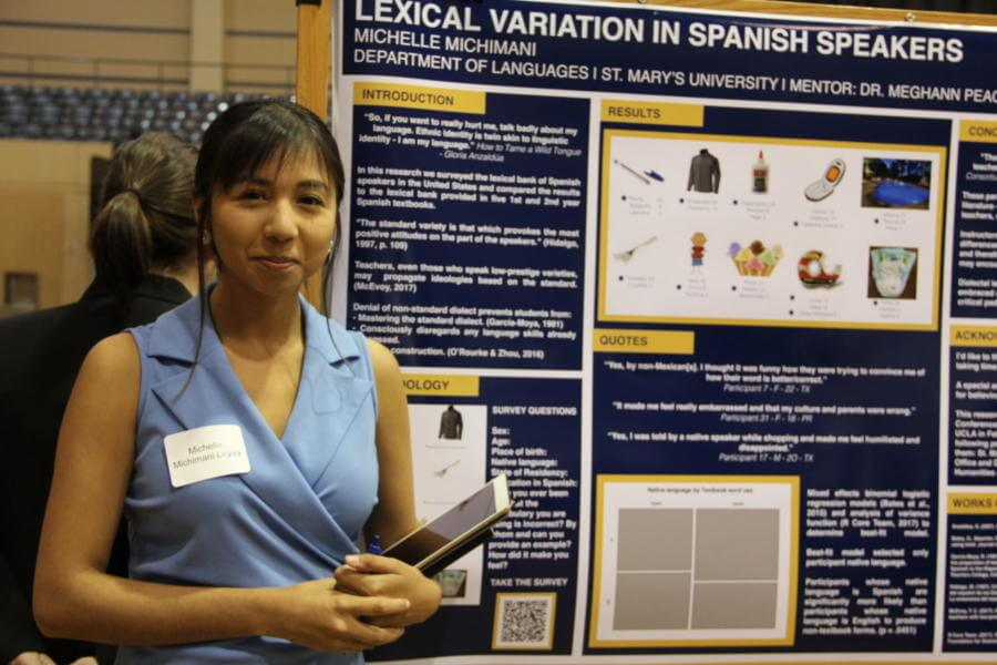 A female student presents her research during the Research Symposium.