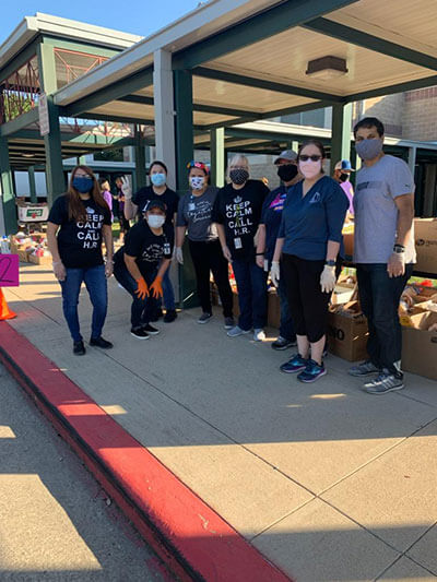 Business alum Jose Placencia volunteers at a food drive