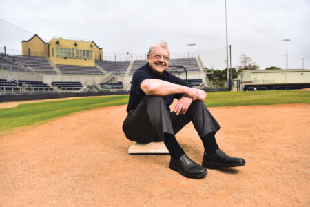 Michael “Mickey” Schott (B.B.A. ’68) sitting on first base