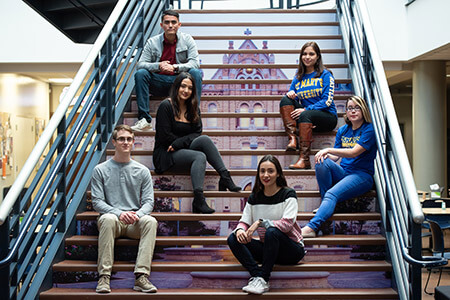 greehey school of business students on stairs