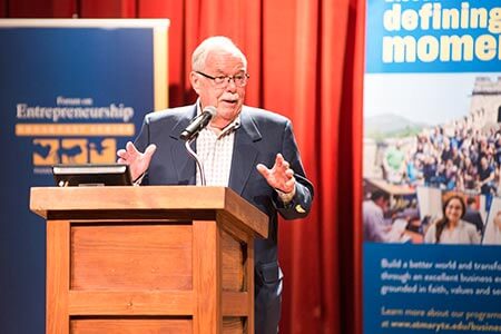 Speaker at podium during Forum Series event