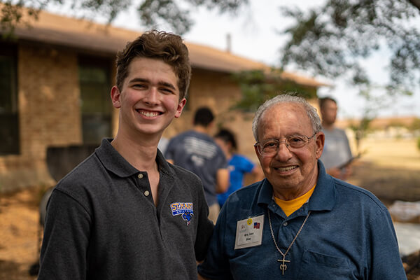 A student poses with a Marianist brother