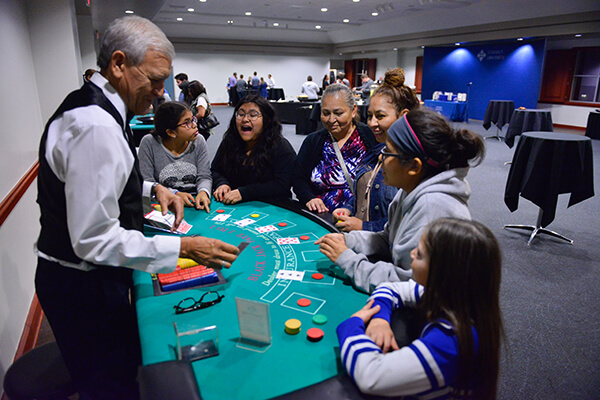 A student and their family play a game at Casino Night