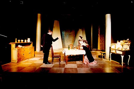 A male and female actor on stage during Miss Julie performance