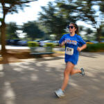 Woman runs in St. Mary's shirt.