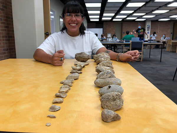 Student Karina Nanez displays rocks from her collection in The Commons.