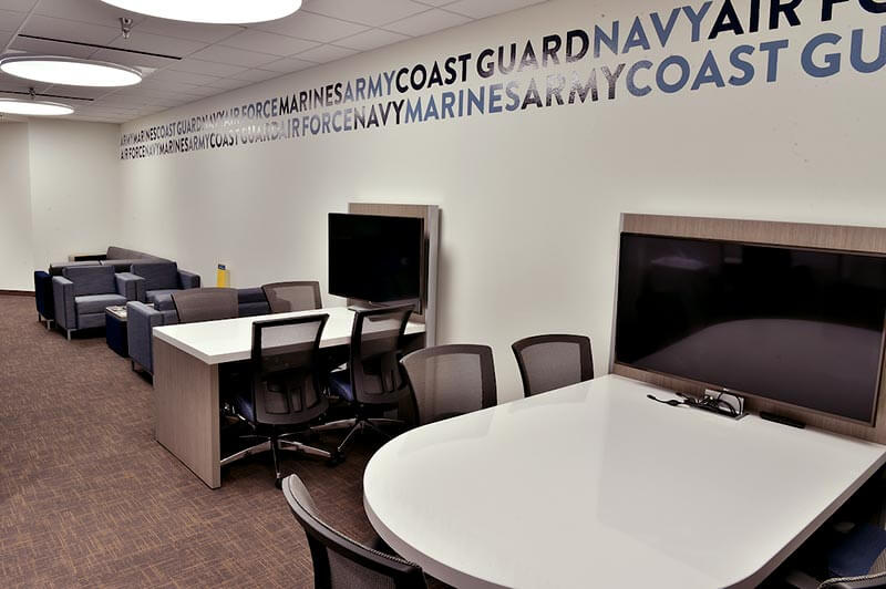 View of the desks, tables, monitors, and couches in the Veterans Center