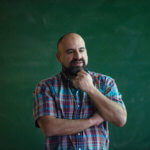 Rick Sperling in front of a blackboard