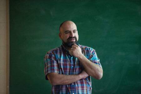 Rick Sperling in front of a blackboard
