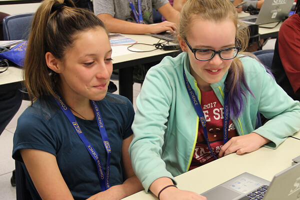 Two females work together during girls code camp.