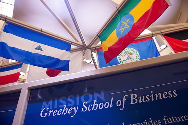 international flags above Greehey School of Business signage