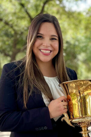 J.D. student Kathryn Cantu holds the David & Linda Schlueter 1L Moot Court trophy