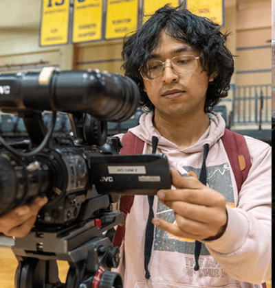 Student films in the Greehey Area using professional photography equipment.