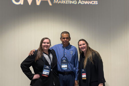 Danielle Hass and Ashley Hass pose with Mathew Joseph, Ph.D., in Orlando, Florida. 