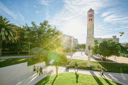 Light shines behind the bell tower.