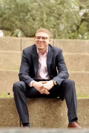 Tromance Washington sits on the amphitheater steps.