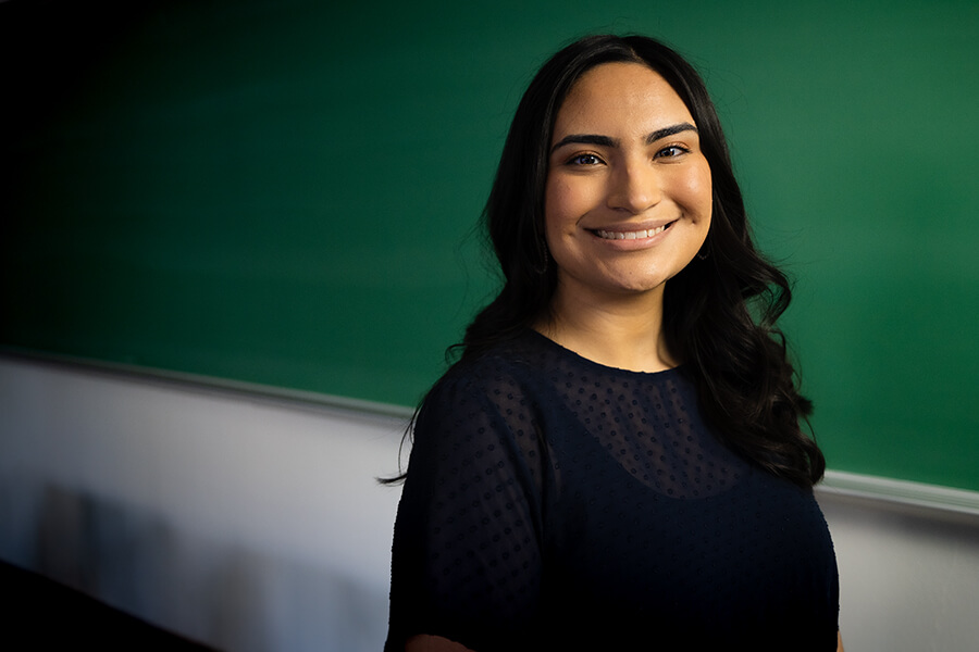 Sierra Salas stands in front of a chalkboard at St. Mary's University.