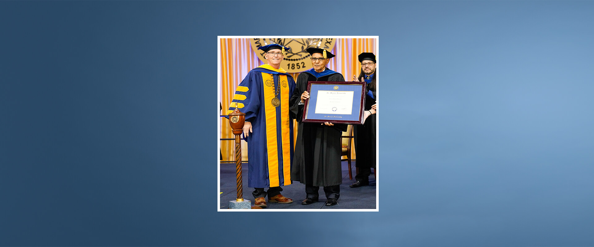 President Thomas Mengler, J.D., left, presents an honorary degree to Charles Anderson on May 14 during the Spring 2022 University Commencement.
