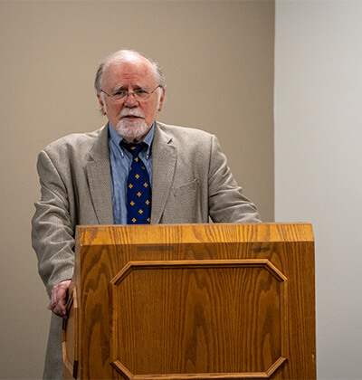 Larry Hufford, Ph.D., stands prepares to give his final lecture at St. Mary's University.
