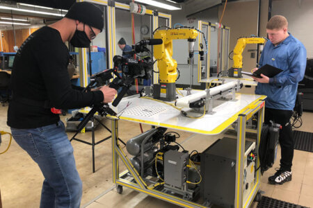 Tromance Washington works in the Engineering lab while filming The College Tour.