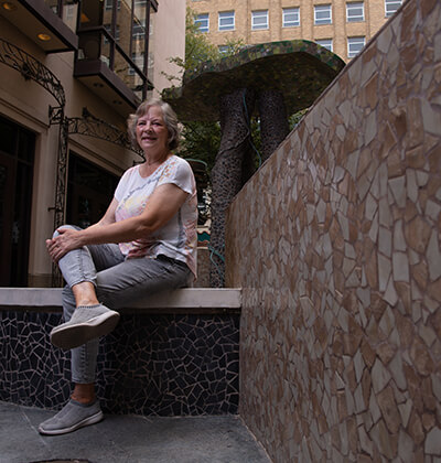 St. Mary's art professor Twyla Arthur poses near her mosaic art piece