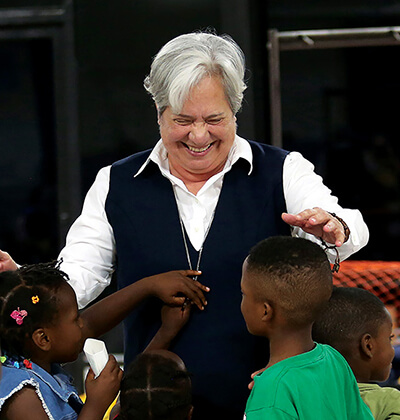 Sister Norma Pimentel smiles as she greets refugee children at the Humanitarian Respite Center
