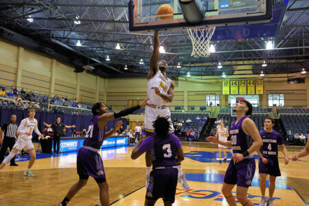 Emmanuel Ewuzie scores a point as a forward on the Rattler Men's Basketball team.