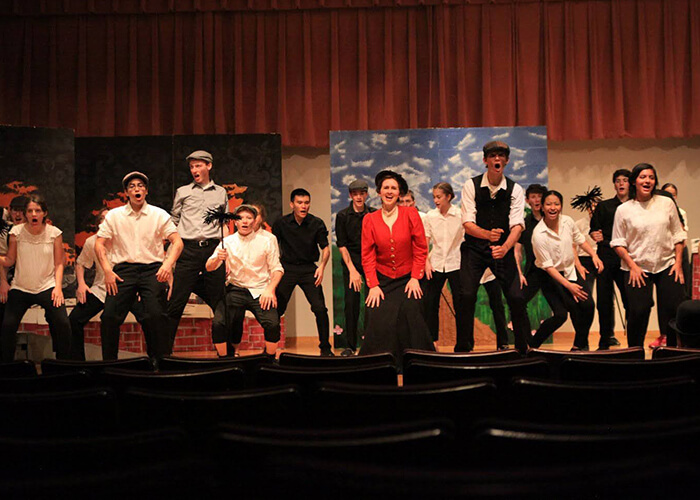 st marys musical theatre camp students performing on-stage in full costumes.