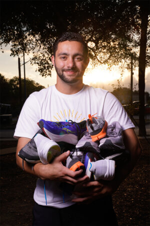 St. Mary's University School of Law student Shawn Barnett poses with donated shoes before a run at Woodlawn Lake Park.