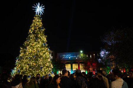 A brightly lit Christmas tree fills Alkek Plaza