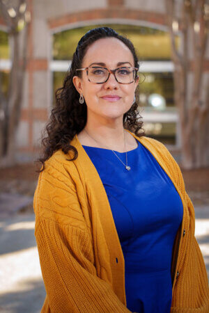 Vanessa Ortega stands in front of the Sarita Kenedy East Law Library.