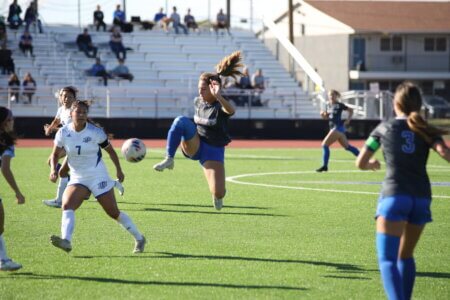 Sydney Varela goes airborne to pass the ball downfield in the quarterfinals of the Lone Star Conference Tournament in Lubbock.