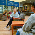 Students chat in the Alkek Building Atrium.
