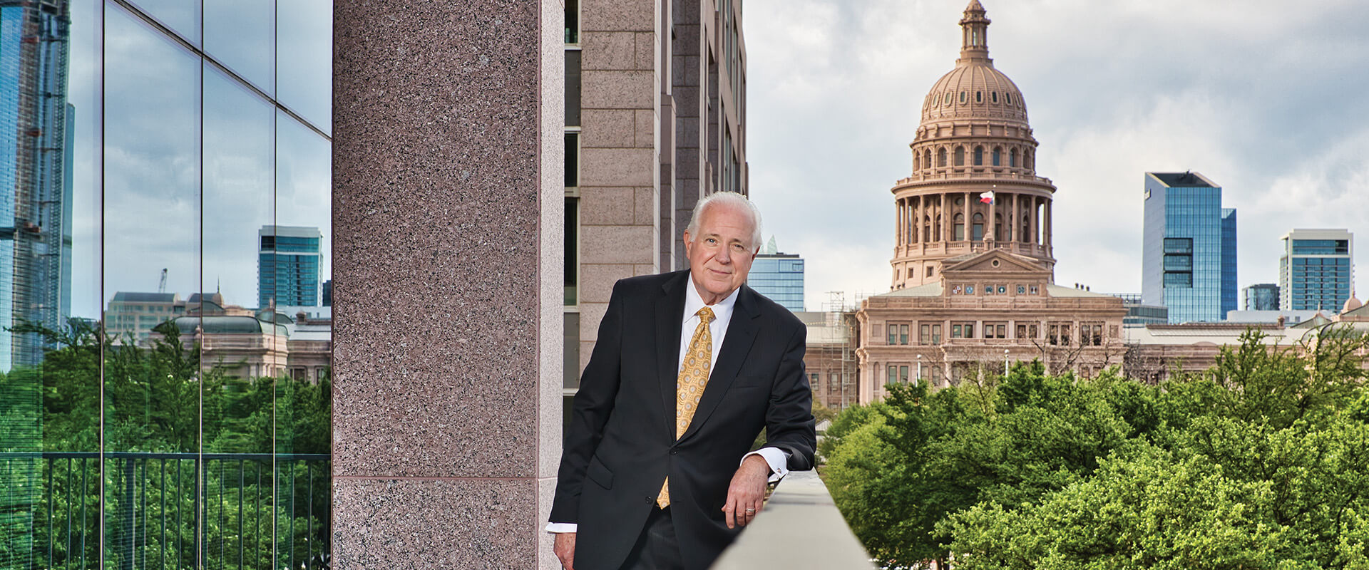 Mike Novak (B.B.A. ’75) poses outside of the capital in Austin.