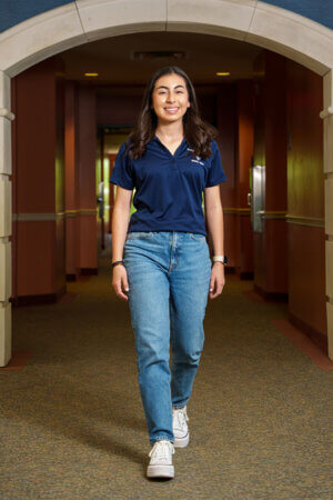 Lucia Martinez walks in Founders Hall.