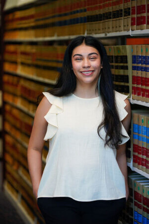Leslie Espiricueta stands in the law library.