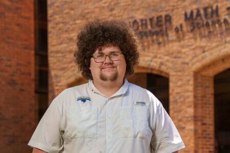 Ian Wells stands in front of Richter building.