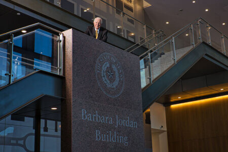 Mike Novak stands in the Barbara Jordan Building staircase.