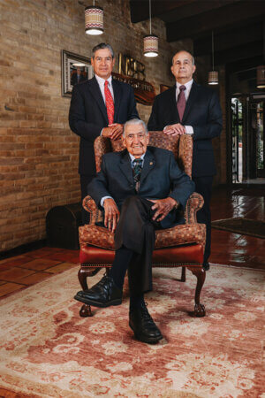 Roy Barrera Sr., center, is surrounded by his son Roy Barrera Jr., left, and his nephew, Gilbert C. Barrera Jr., in the family's law office.