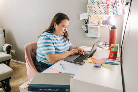 Helena Hernandez Fisher works on an assignment for the Online J.D. Program.