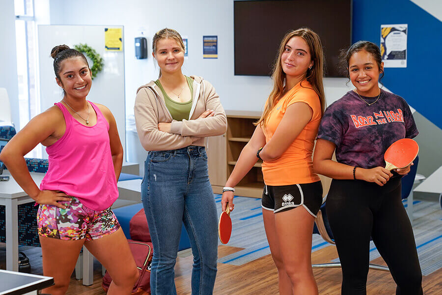 Four students in athletic gear