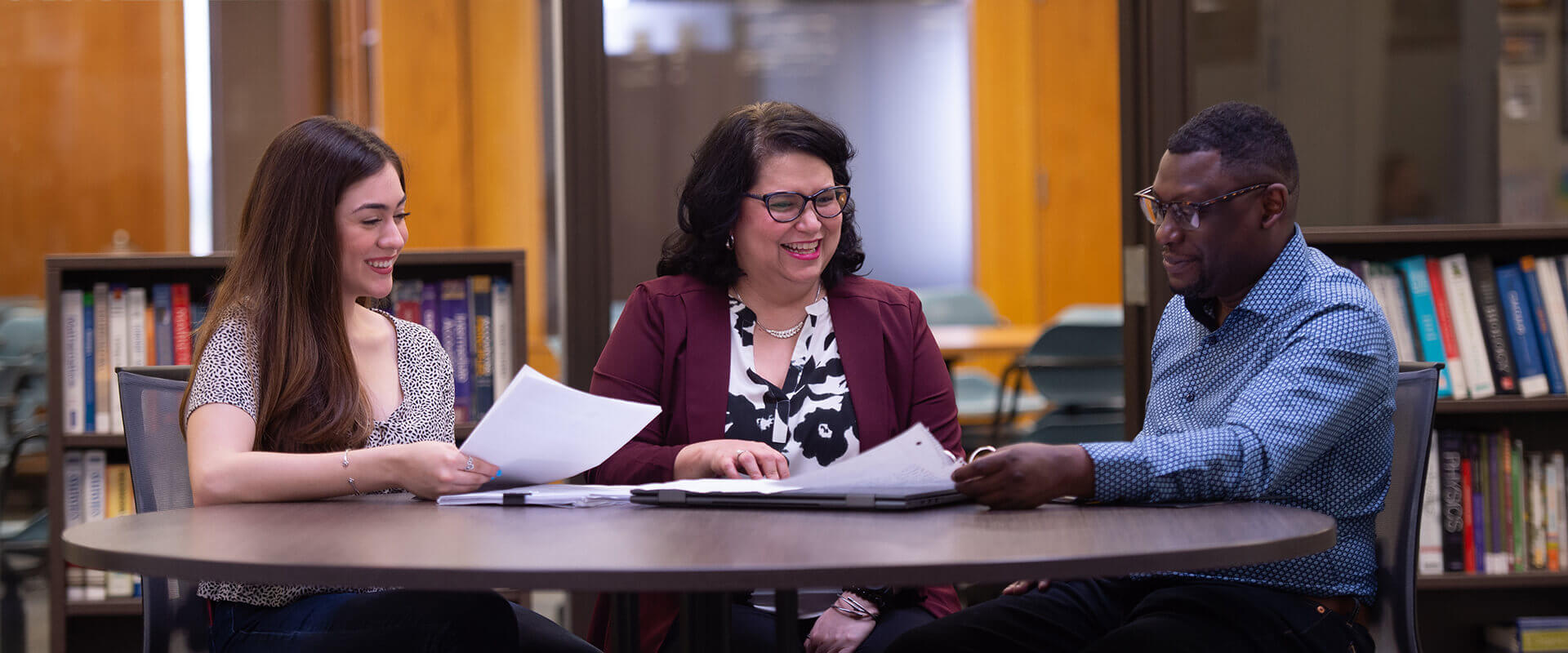 Two students sit with an academic adviser at the Rattler Student Success Center.