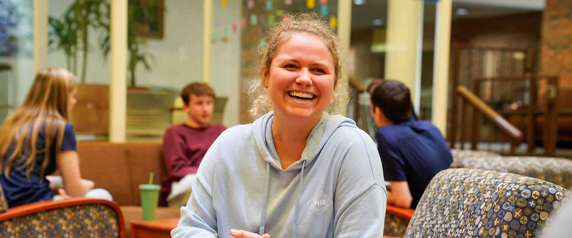 Student smiling sitting in chair