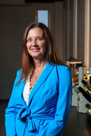 Donna Badowski stands in a biology lab on campus.