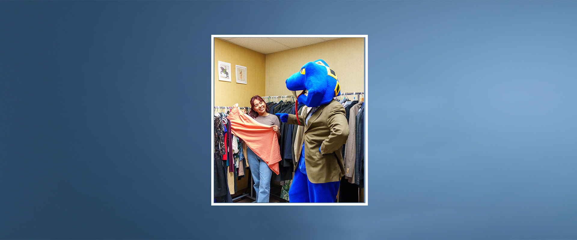 Rattlerman assists a student select an item from the Greehey School of Business Rattler Wardrobe.