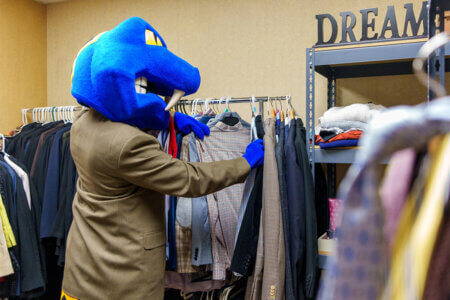 Rattler Man looks for a coat at the Rattler Wardrobe.
