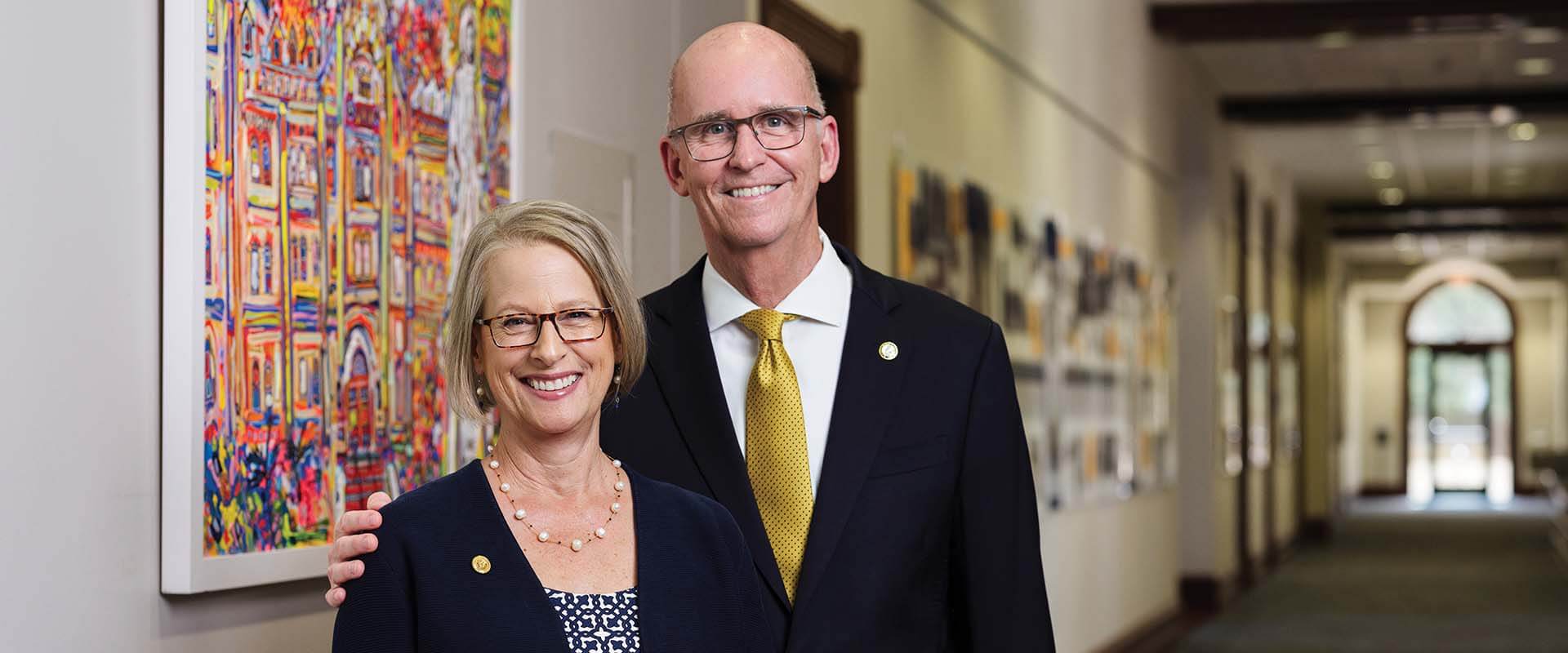 St. Mary’s University President Thomas M. Mengler, pictured right, and his wife, Mona Mengler, stand in front of Ave Maria, a painting commissioned to celebrate the conclusion of The Defining Moment Comprehensive Campaign.
