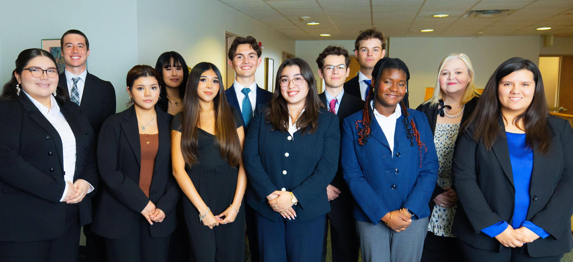 A group of students lined up and smiling for the camera.