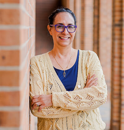 Belinda Ramon, Ph.D., stands outside the Commons.