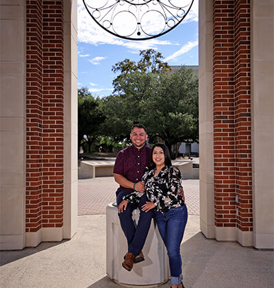 Marina Salgado (B.A. ’17) and her husband, Mario Salgado (B.A. ’17) take an engagment photo under the Barrett Memorial Bell Tower.
